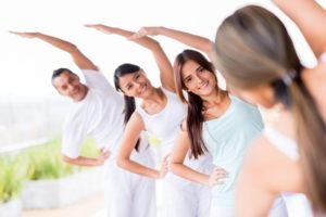 Group of people practicing yoga and stretching